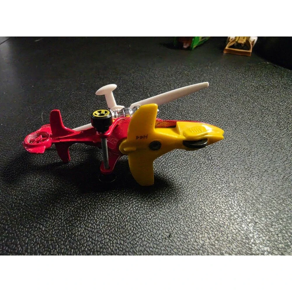 Lot of 4 loose Hot Wheels vehicles in pre-owned condition.